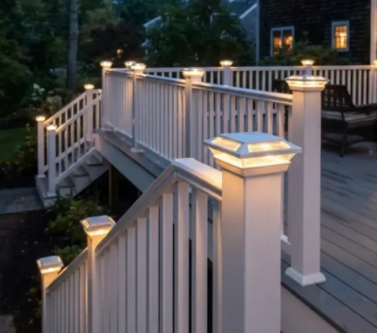 White deck with LED post cap lights glowing at twilight